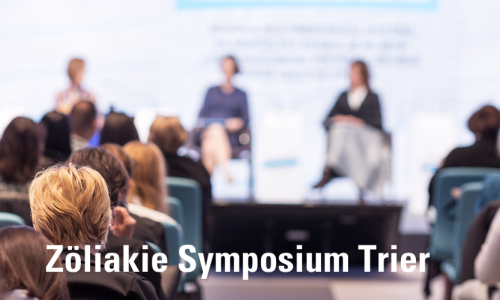 Podium mit Rednern und davor viele Zuhörer - darunter steht Zöliakie Symposium Trier